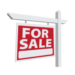 A for sale sign hanging from the side of a pole.
